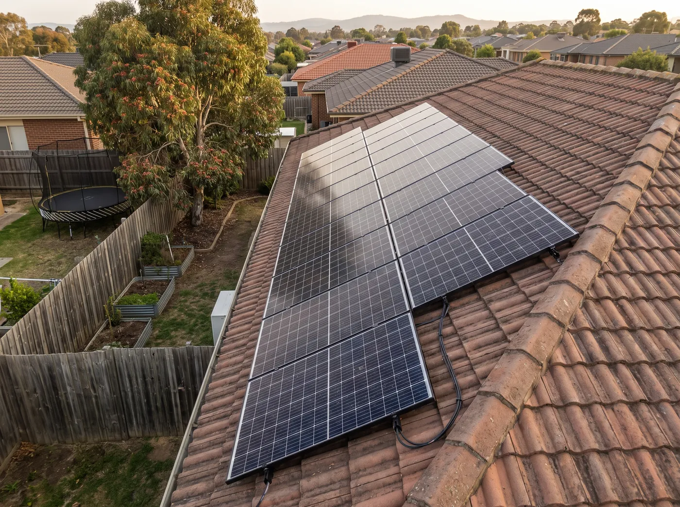 Completed all-black solar array on a terracotta roof